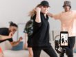 people recording themselves dancing while in front of a smartphone at their living room