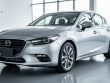 Silver sedan photographed at eye level with clean studio lighting and a blurred, distraction-free background focusing on the vehicle’s front end.