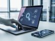 Laptop and smartphone on a modern desk with abstract AI and search icons, illustrating updated SEO tools and spam detection signals in 2026.